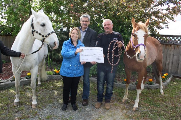 PG-Mackenzie MLA Mike Morris and PG-Valemount MLA Shirley Bond present funding to PG Agricultural and Historical Association president Alex Huber - photo courtesy provincial government
