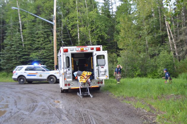 Firefighters emerge from bush off Shetland Road Friday night after responding to quad mishap. Photos 250News