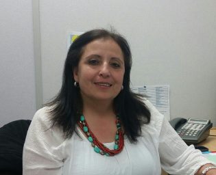 Rose Toume takes a seat in her shared office at IMSS - photos 250News