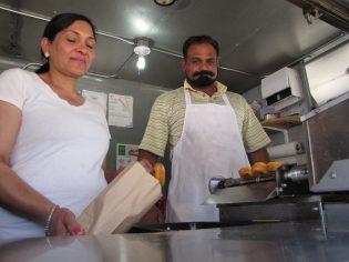 Kulwinder Bhatal and Husband Parmjit package up hot mini donuts