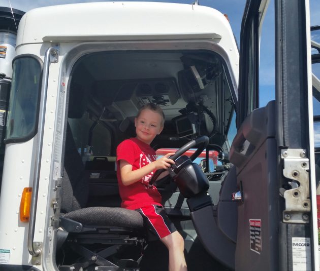 Riley Spooner hops aboard a city truck