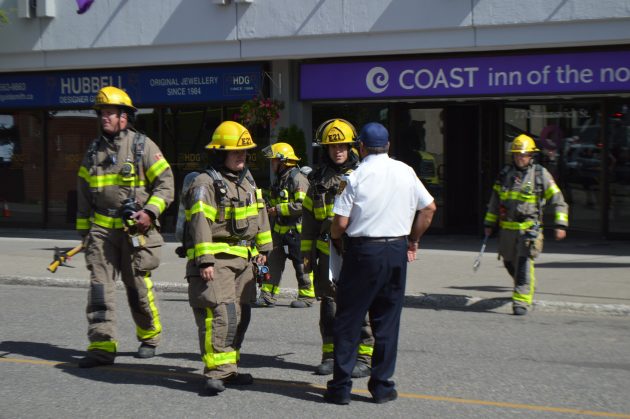 Assistant Fire Chief Denis Poulin (white shirt) talks with firefighters who searched the Coast Inn Sunday afternoon. Photos 250News