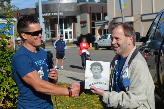 Jim Terrion (right) receives his one-of-a-kind plaque from the Fox family from Scott McWalter.