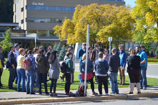 Participants gather at 6th and George prior to a walking discussion on shaping a liveable downtown.