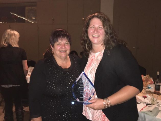 Jackie Benton and Christina Rossi accept the Citizen of the Year award on behalf of Diane Rossi.