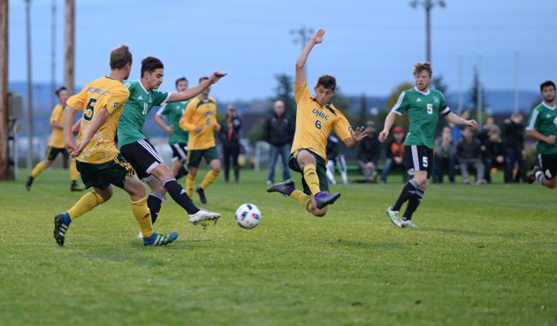 UNBC's Cody Gysbers (6) tries to block shot from Gabriel Buatois of the Huskies Friday night. Saskatchewan won 3-0. Photo Matt Wood/UNBC