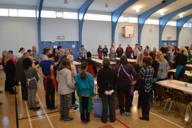 Bernie Goold gives her volunteer team some instruction prior to serving Thanksgiving dinner at Sacred Heart auditorium. Photos 250News