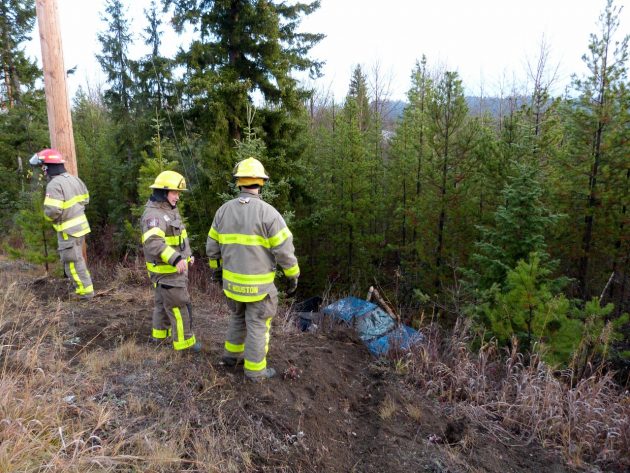 Prince George Fire Rescue members view pick-up from the side of Otway Road. Photo 250News