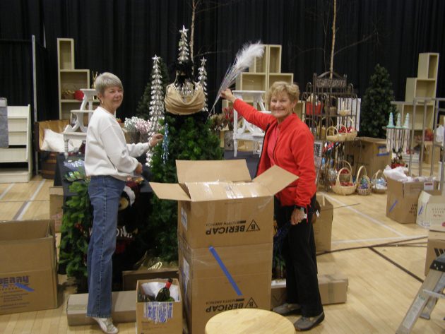 From left, Festival of Trees volunteers Sharon Willoughby and Gayle Magrath during set up on Tuesday - photos 250News