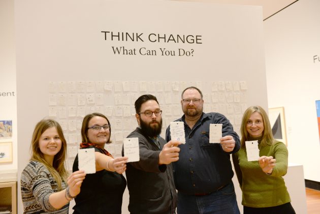From left: UNBC student Carleen Paltzat, UNBC Associate Geography Professor Dr. Zoë Meletis, UNBC Assistant Environmental Planning Professor Dr. Mark Groulx, Two Rivers Curator and Artistic Director George Harris, and Two Rivers Managing Director Carolyn Holmes hold up some of the messages left on the Think Change wall at the exhibit - photo courtesy UNBC