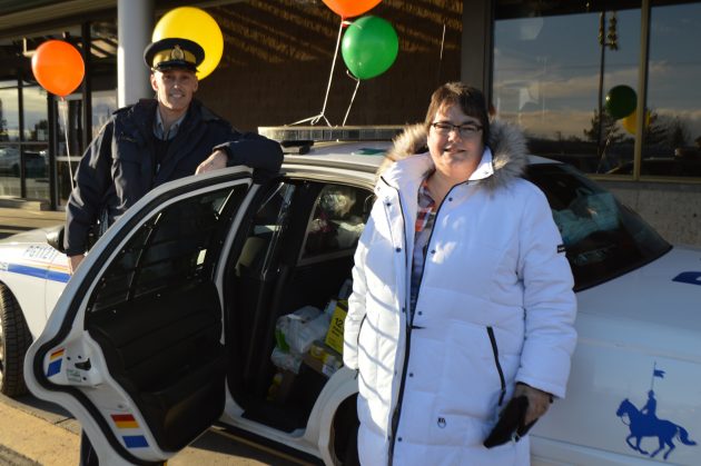 Cpl Craig Douglass and organizer Beverly Livingstone outside the Spruceland Save-On-Food store Saturday. Photo 250News