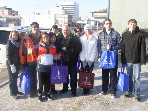 JET program coordinator Jason Dauvin (middle) and students prepare to donate 'Jet Packs' to the St. Vincent de Paul Society Wednesday - photo 250News