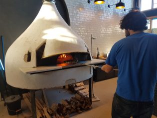 Staff practice making pizza